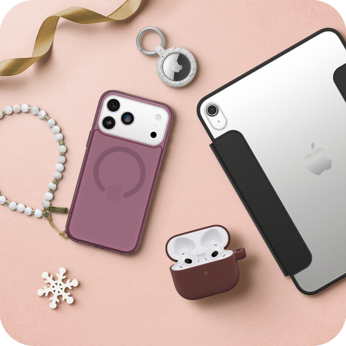 Smartphone, AirPods case, and accessories on a pink surface
